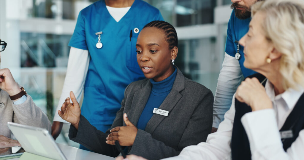 Staff in the medical field meeting for task delegation or planning.